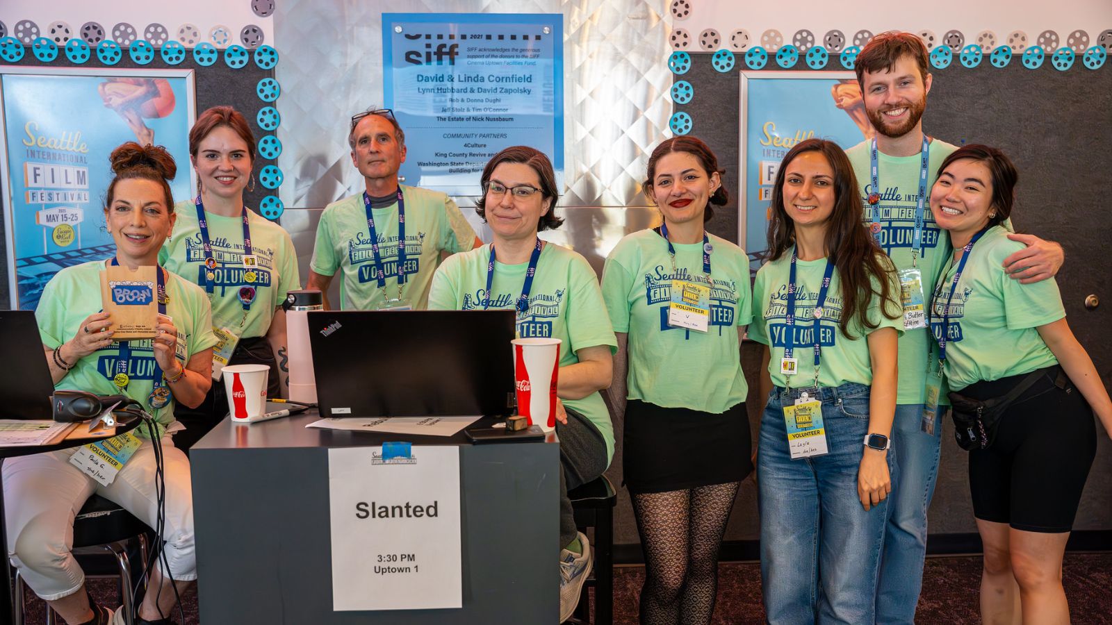 Group of eight volunteers pose at SIFF Cinema Uptown during the 51st Seattle International Film Festival