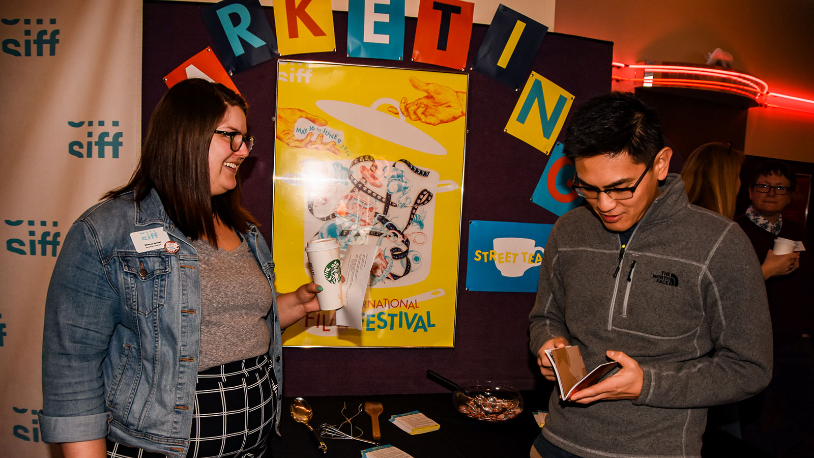 Marketing Coordinator with attendee at Volunteer Meeting